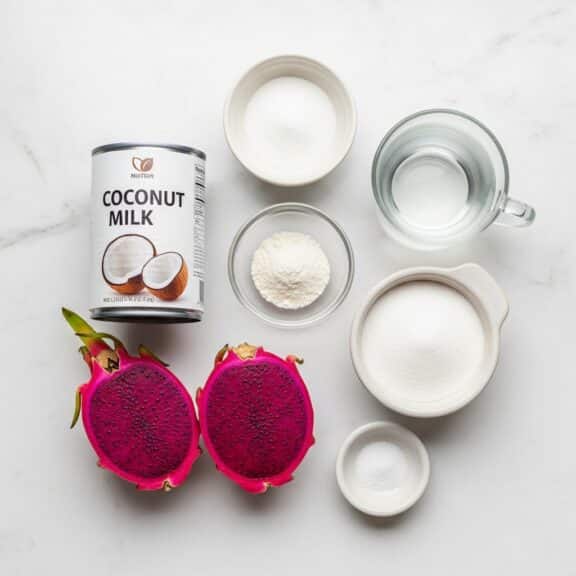 Creative Jello Desserts ingredients including dragon fruit, coconut milk, sugar, gelatin powder, and water arranged on a white surface.