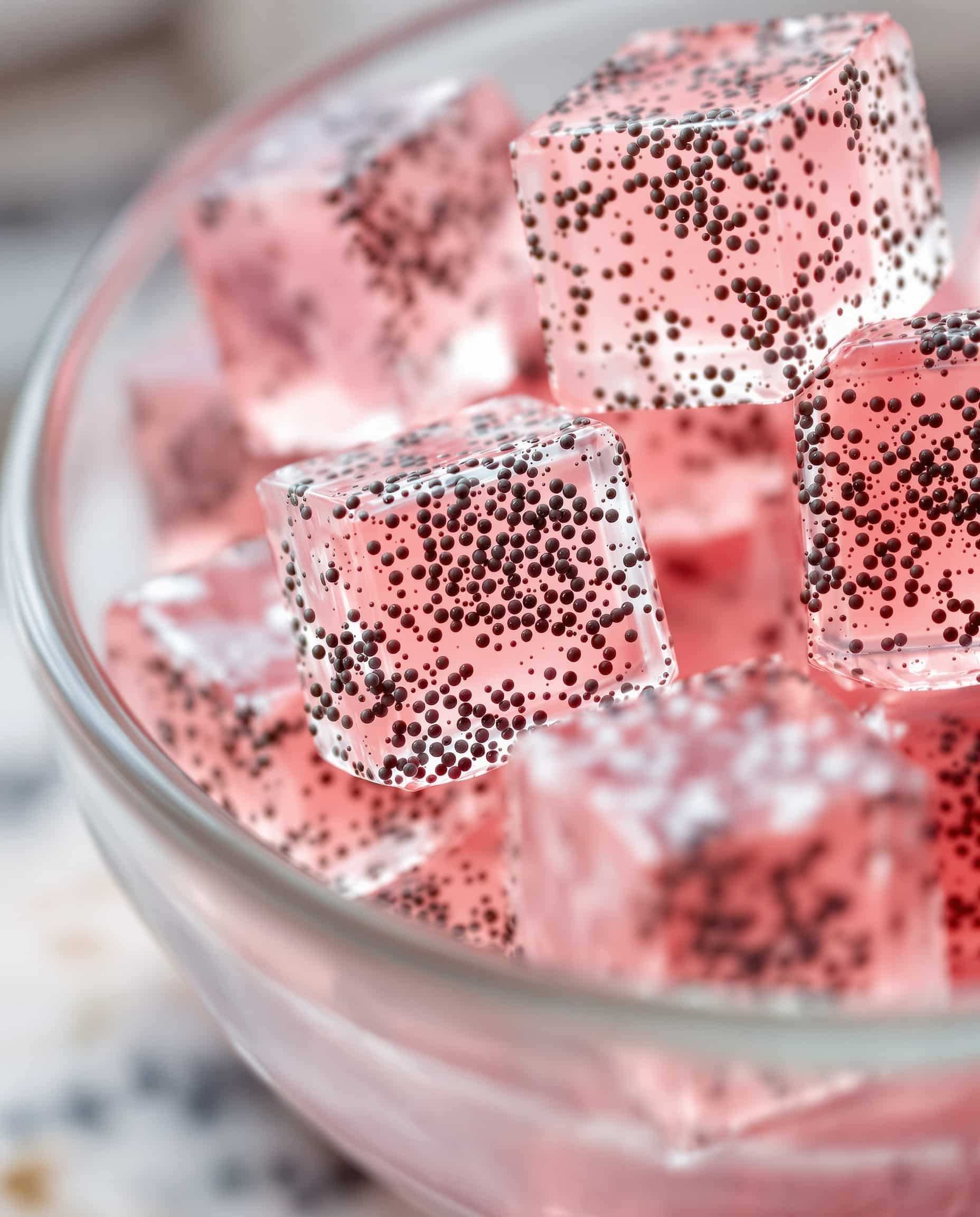 Close-up of rose-vert gelatin trick with chia seeds cubes.